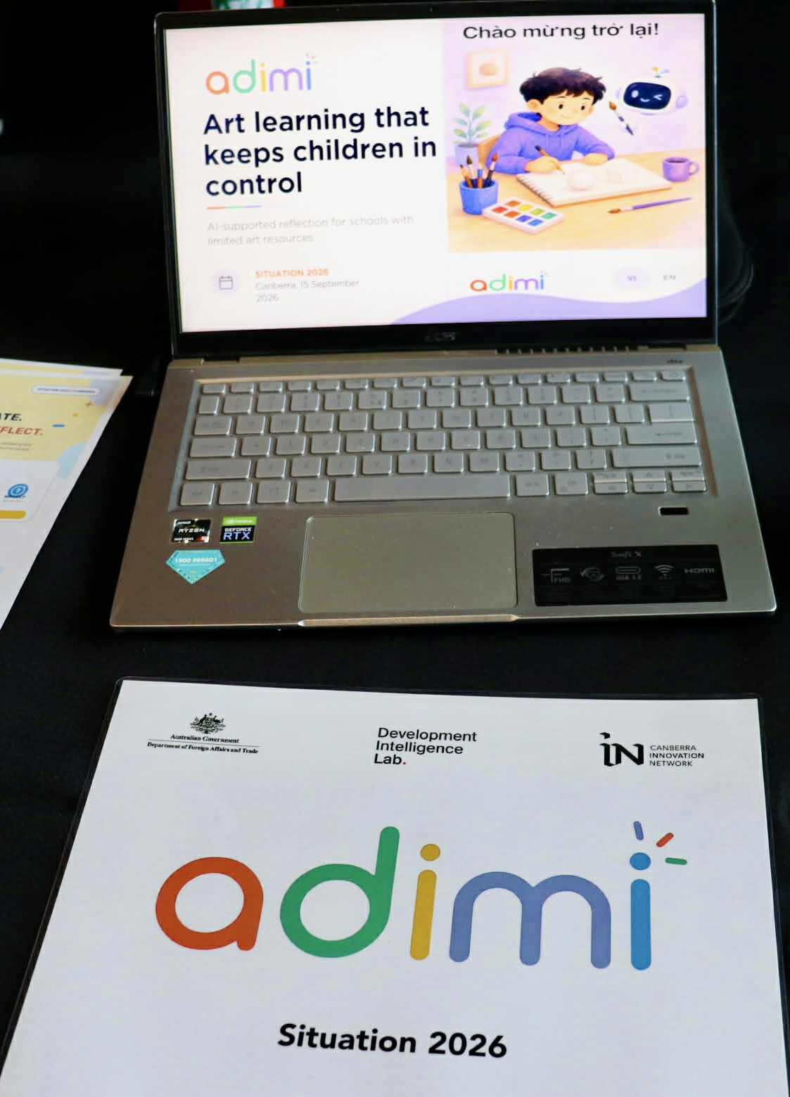Close-up of Adimi pitch materials and brochure at Situation 2026