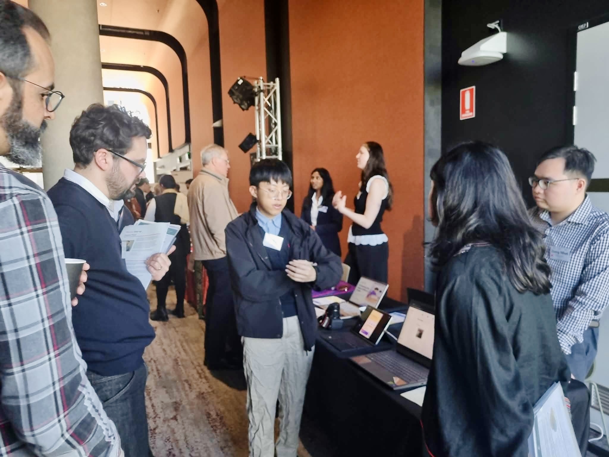 Adimi team talking with visitors at the exhibition